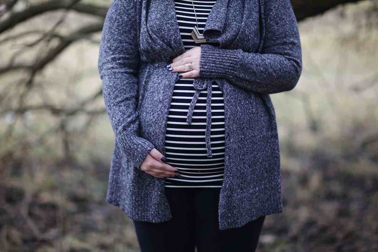 Picture of a pregnant woman holding her stomach